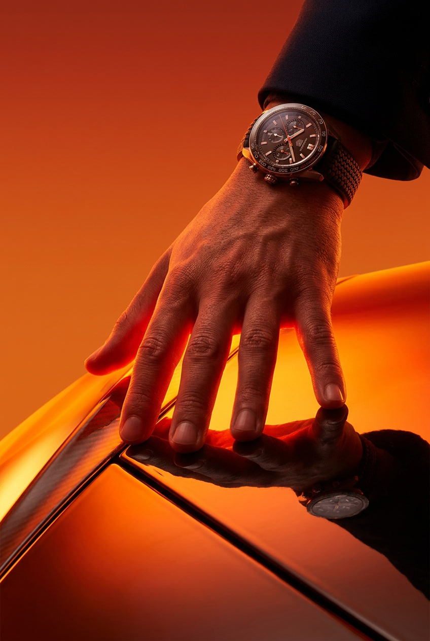 Young man in an orange jacket and orange sunglasses.
